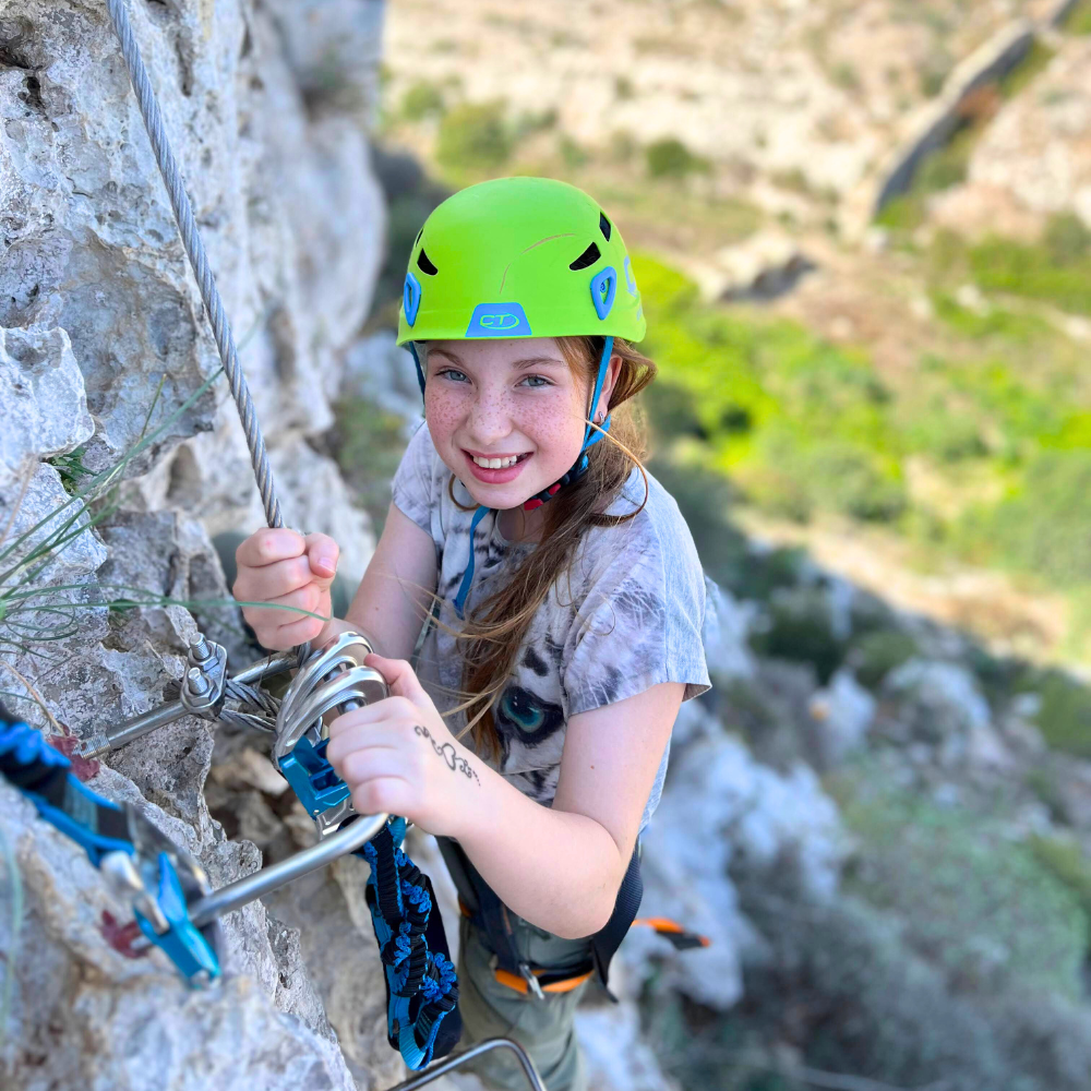 Young girl smiling while clipped to the Via Ferrata in Malta.